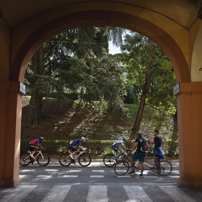 Giro dell’Emilia 2025 - Fans on a tandem watch the race from an archway in Bologna