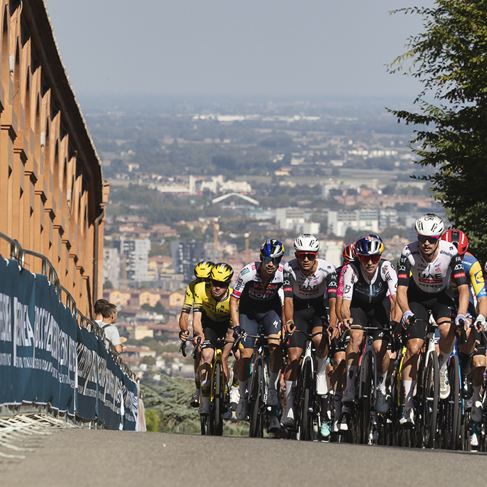 Giro dell’Emilia 2025 - The peloton on the San Luca climb alongside the Portico with the city of Bologna as a backdrop