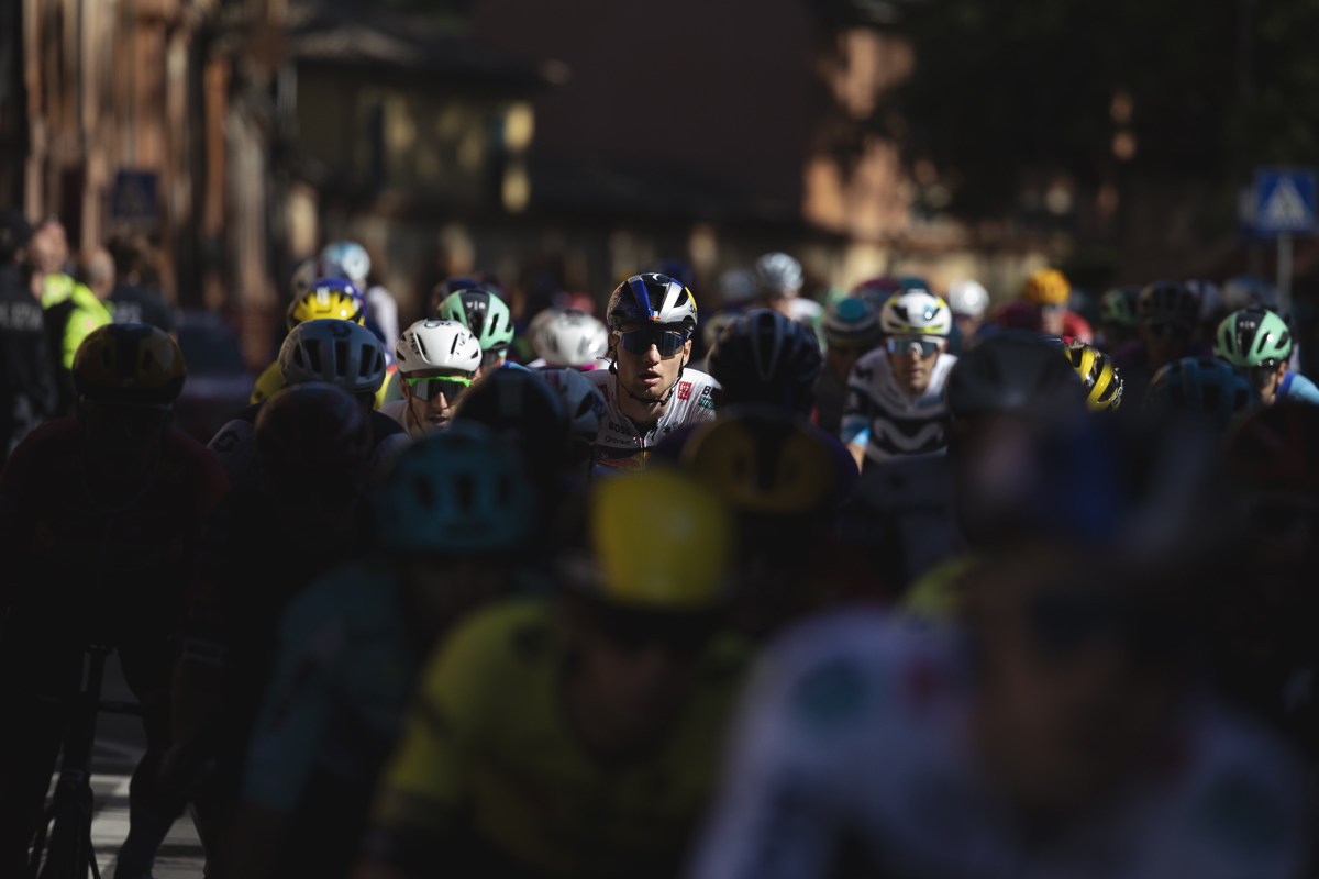 Giro dell’Emilia 2025 - Aleksandr Vlasov picked out by the light in the peloton