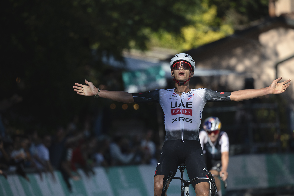 Giro dell’Emilia 2025 - Isaac del Toro stretches out his arms as he crosses the finish line victorious