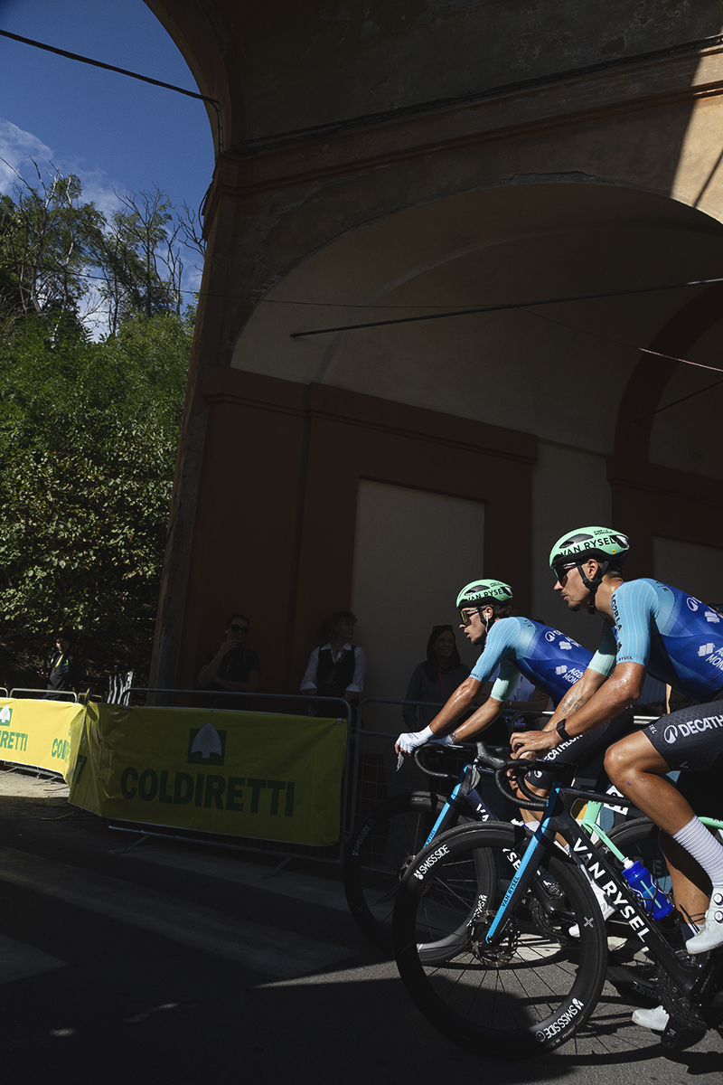 Giro dell’Emilia 2025 - Noa Isidore and Jordan Labrosse pass under one of the gateways on the San Luca climb