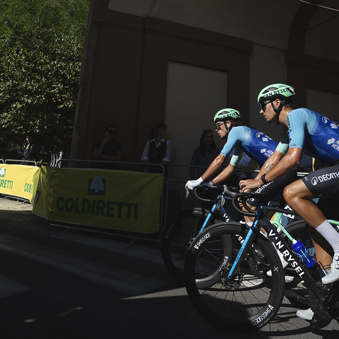 Giro dell’Emilia 2025 - Noa Isidore and Jordan Labrosse pass under one of the gateways on the San Luca climb