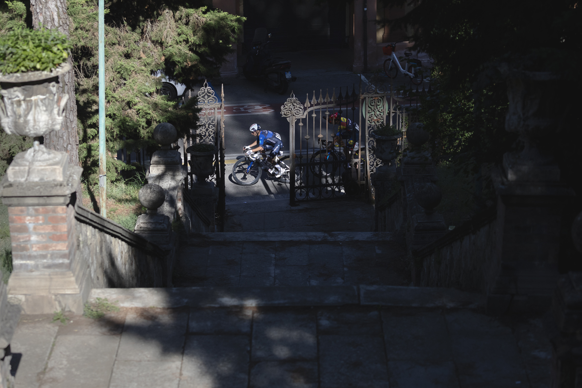 Giro dell’Emilia 2025 - Rémy Rochas framed by ornate gates in Bologna
