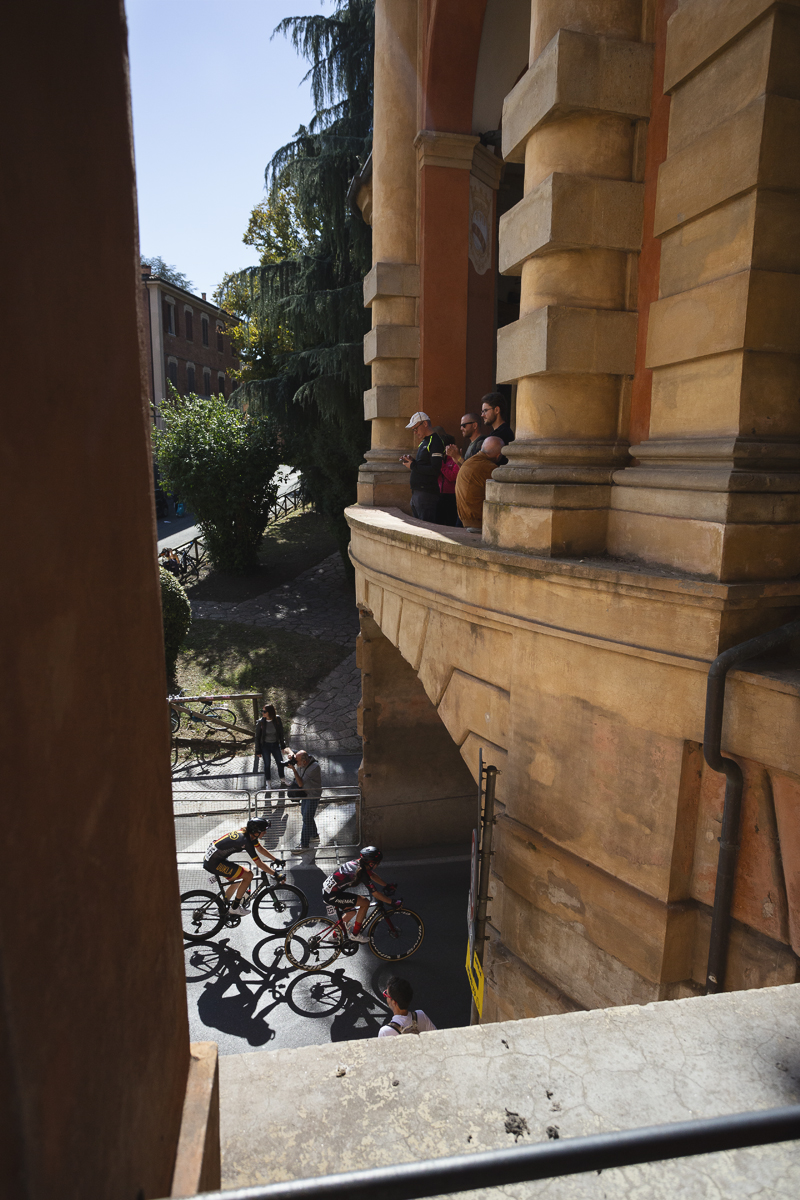 Giro dell'Emilia Internazionale Donne Elite 2025 - Riders cast long shadows as they pass under the Arco del Meloncello