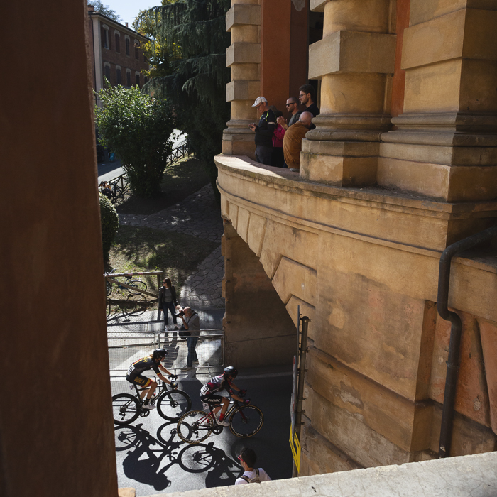 Giro dell'Emilia Internazionale Donne Elite 2025 - Riders cast long shadows as they pass under the Arco del Meloncello
