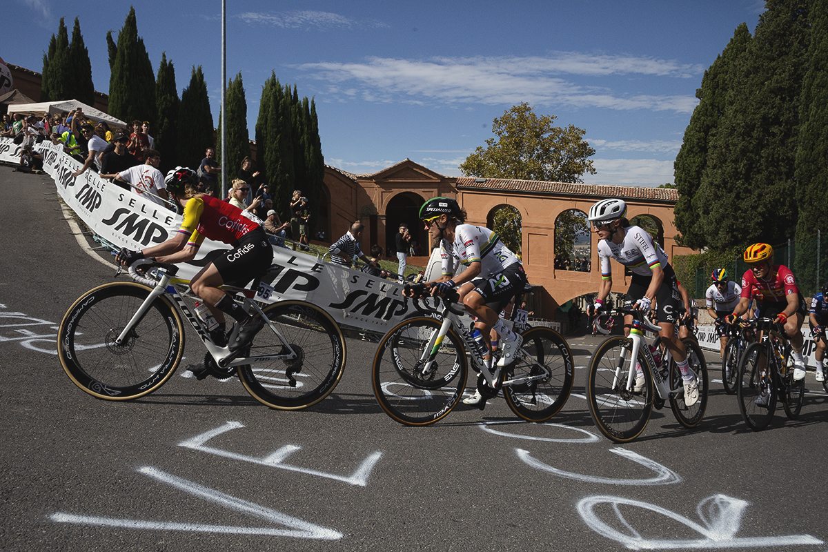 Giro dell'Emilia Internazionale Donne Elite 2025 - Riders pass over chalk messages written on the road on their way up the climb