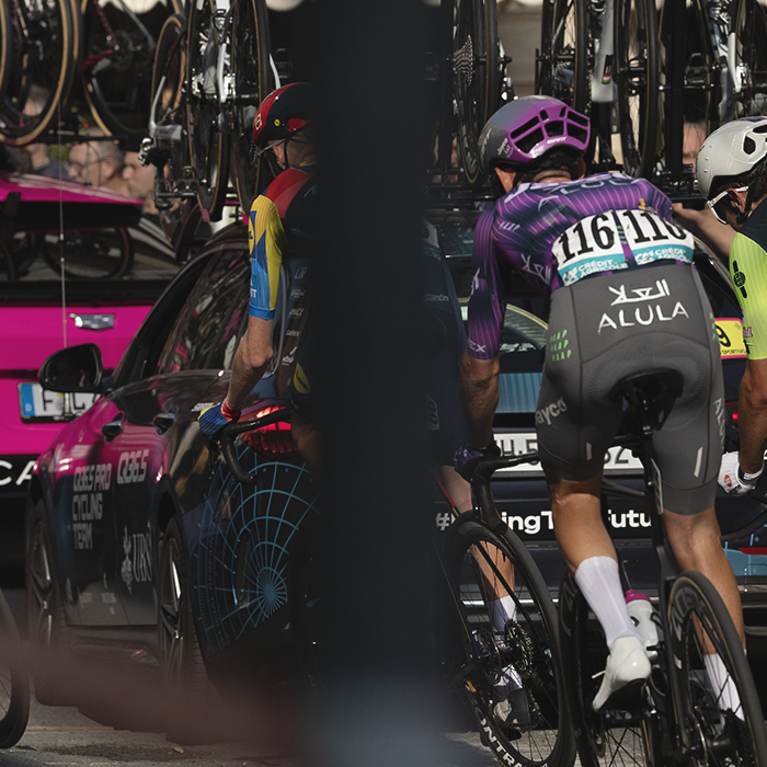 Gran Piemonte 2025 - Riders in the race convoy round a corner