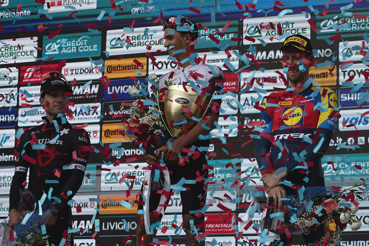 Gran Piemonte 2025 - The podium is showered in red and blue confetti as the riders are presented with their prizes