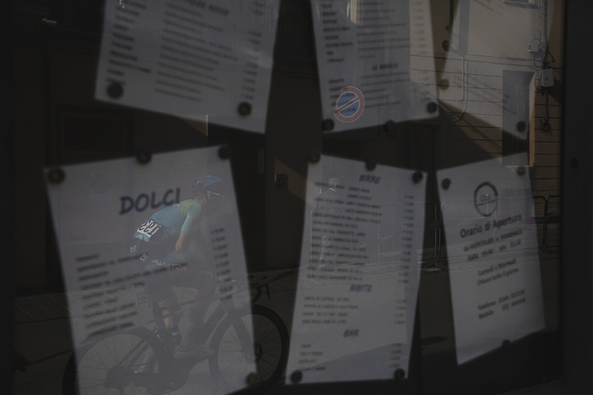 Gran Piemonte 2025 - Clément Champoussin is reflected in the menu board posted outside a restaurant in Acqui Terme