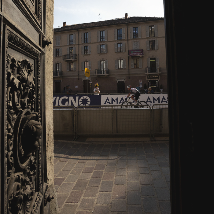 Gran Piemonte 2025 - Domen Novak is viewed though the ornate door of a church during the race