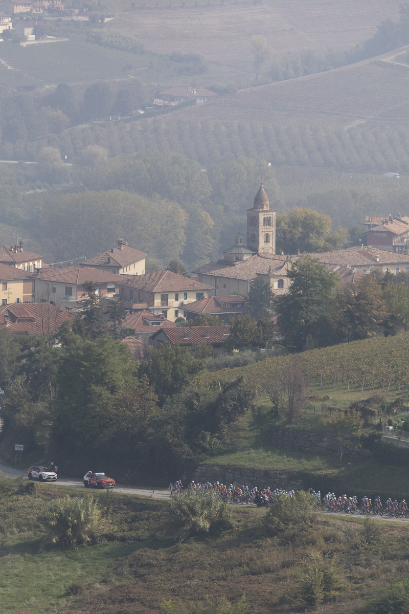 Gran Piemonte 2025 - Riders seen in the Piemonte vineyards with the settlement of Annunziata in the background