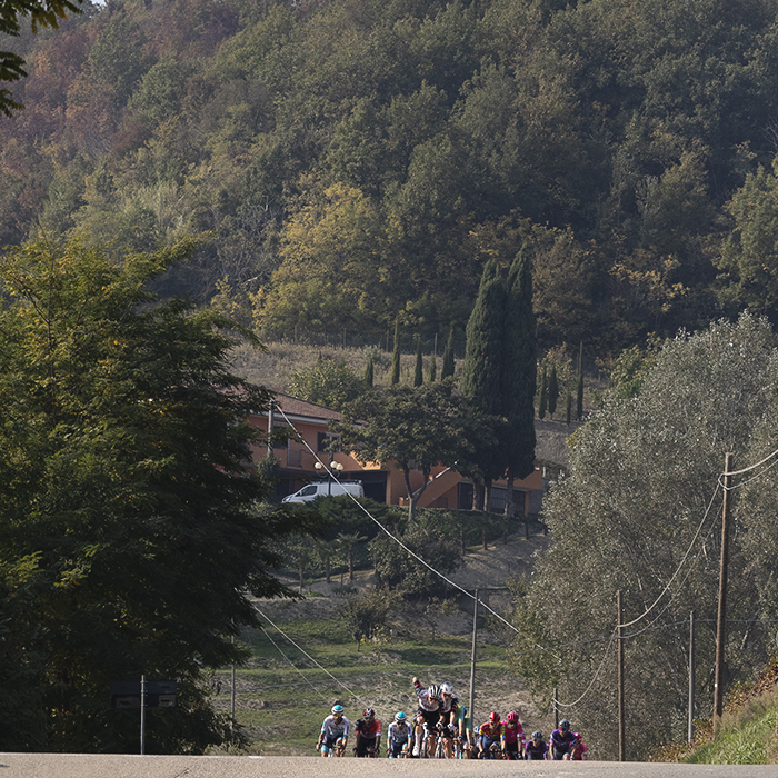 Gran Piemonte 2025 - A group of riders crest a rise in Castel Boglione