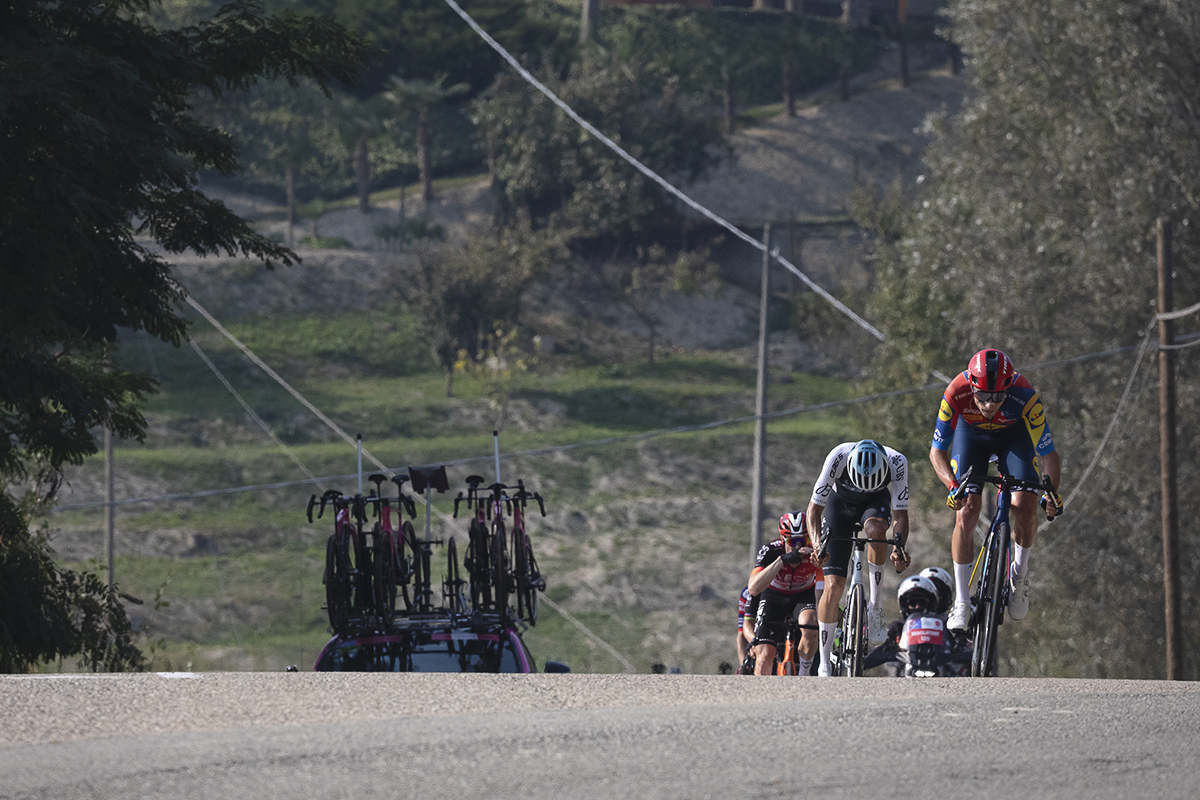 Gran Piemonte 2025 - A group of riders push onwards up an undulation in the road in Castel Boglione