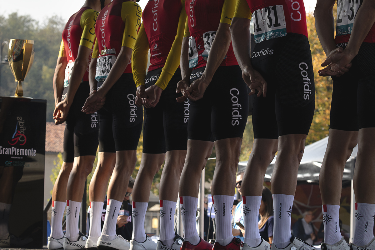 Gran Piemonte 2025 - The Cofidis team are seen from behind on the podium with the race trophy to one side