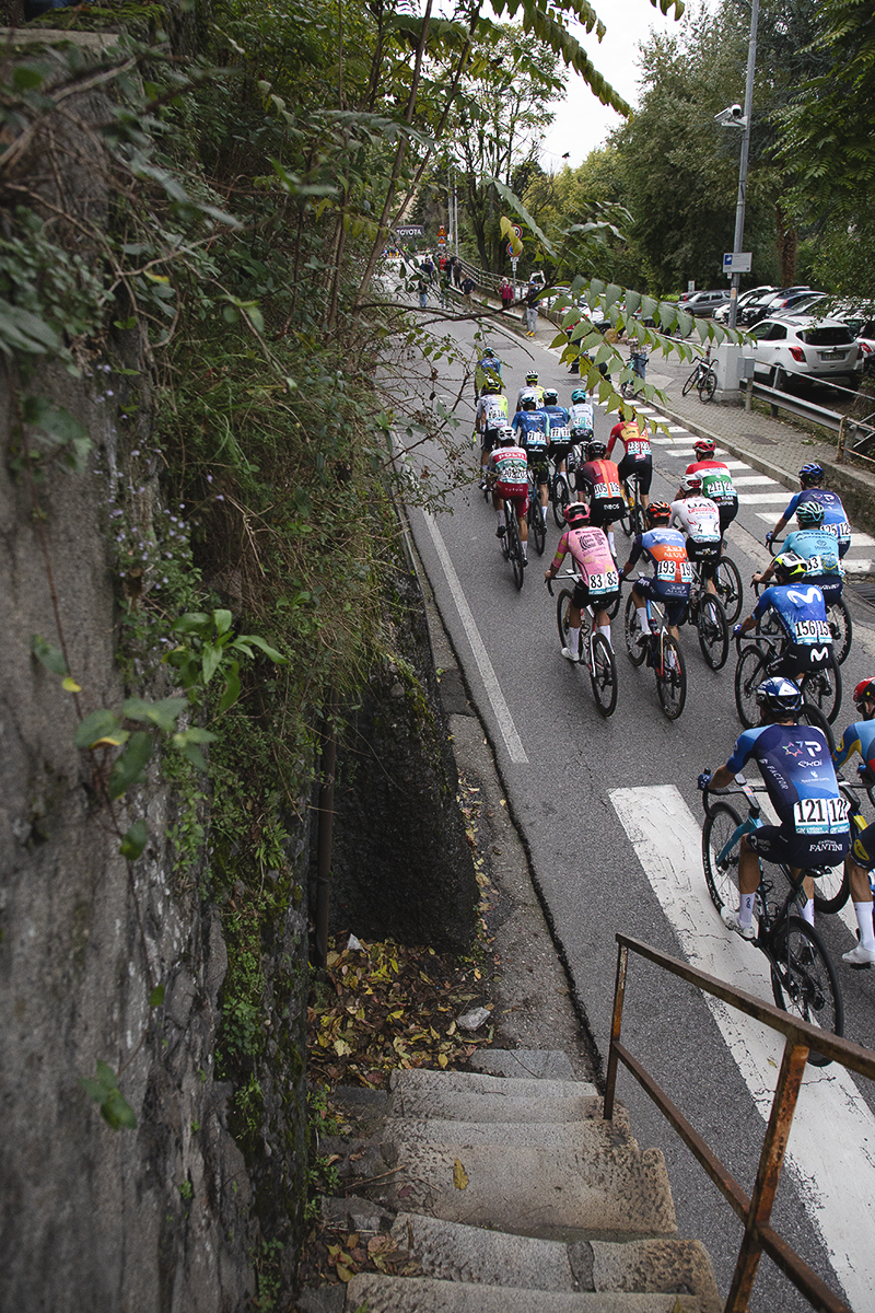 Il Lombardia 2024 - A group of riders seen from the top of old stone steps in Como