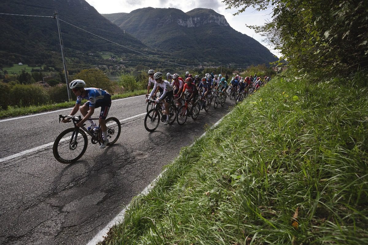 Il Lombardia 2024 - The peloton climbs in front of hills in Dosso