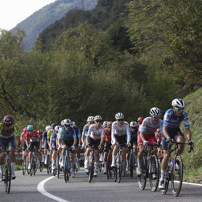 Il Lombardia 2024 - Riders climb on the outskirts of Dosso with lush hills as a backdrop