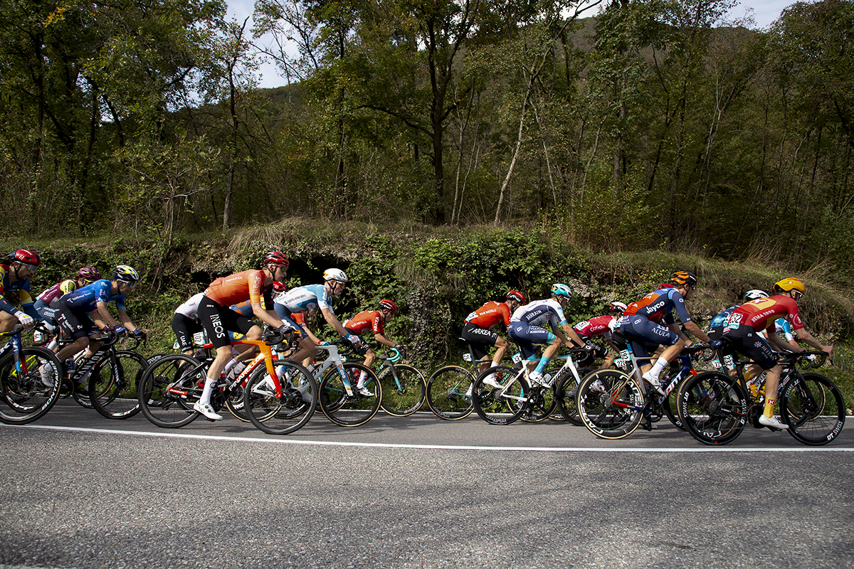 Il Lombardia 2024 - Riders pass caves in the hillside in Dosso