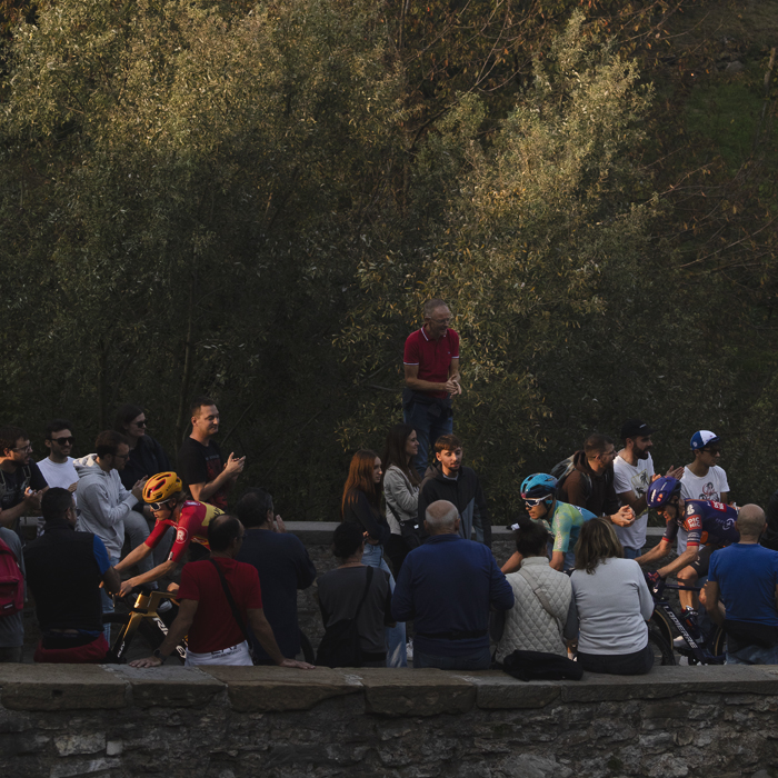 Il Lombardia 2025 - Fans stand and sit on walls at the side of the road to get a vantage point as the riders pass by in Bergamo