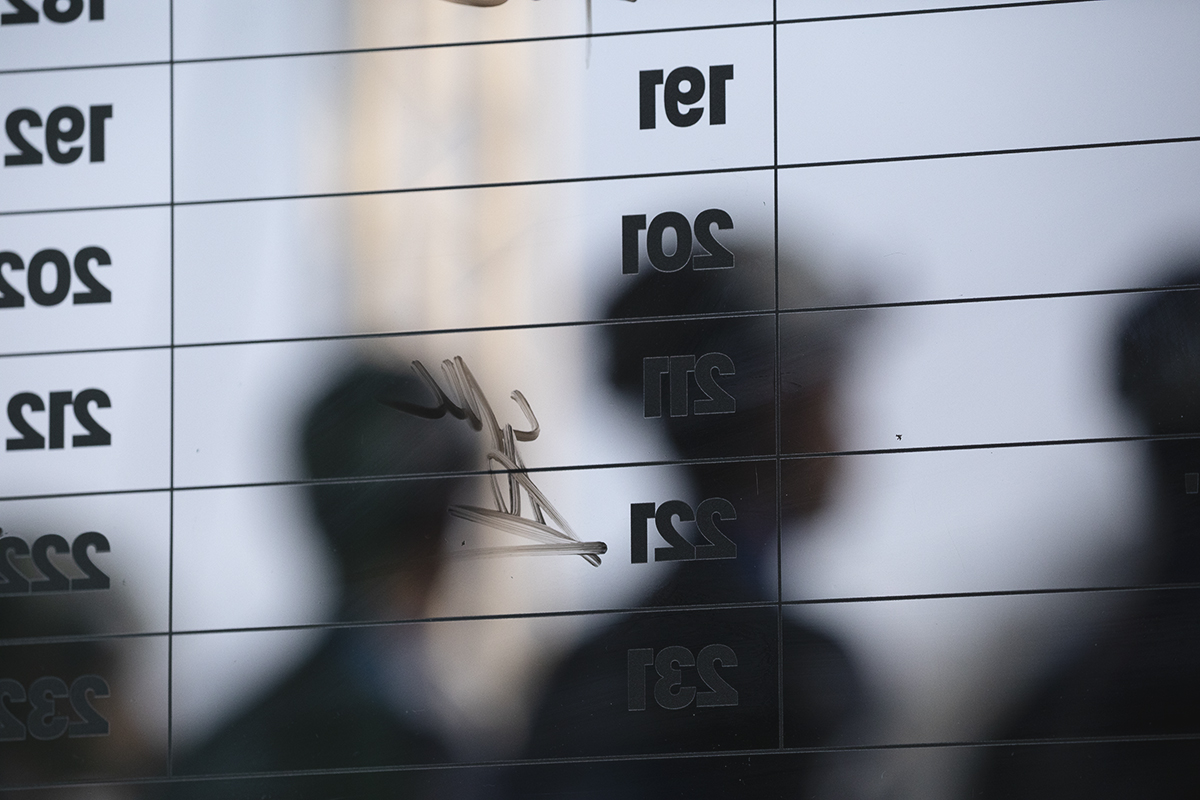 Il Lombardia 2025 - Riders are seen through the sign on board lining up to be presented to the crowd