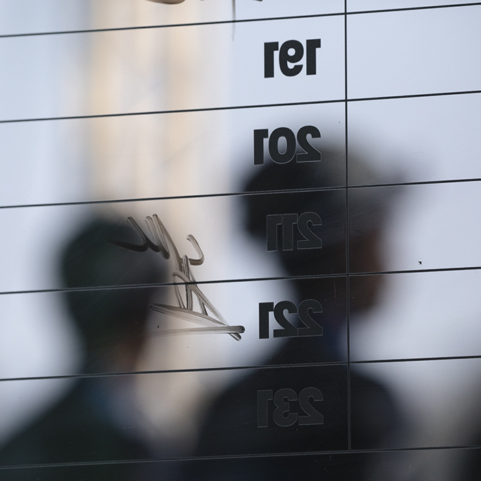 Il Lombardia 2025 - Riders are seen through the sign on board lining up to be presented to the crowd