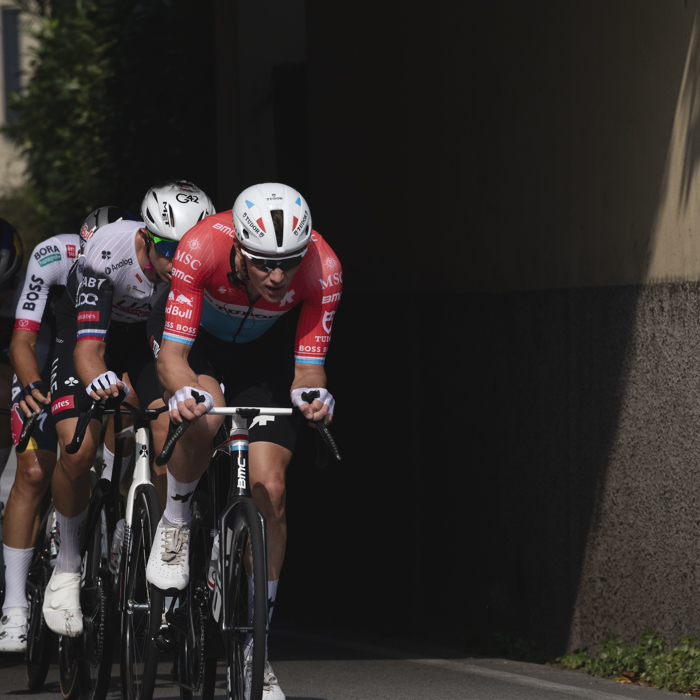 Il Lombardia 2025 - Luxembourg champion Arthur Kluckers races out of deep shadow cast by a traditional Italian building