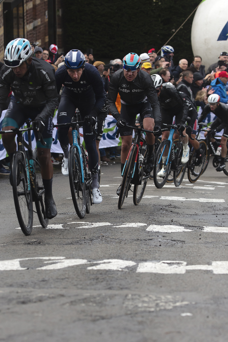 La Flèche Wallonne 2024 - Eventual winner Stevie Williams  in a group of riders on the Mur de Huy, with Huy painted on the road