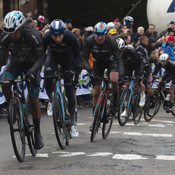 La Flèche Wallonne 2024 - Eventual winner Stevie Williams  in a group of riders on the Mur de Huy, with Huy painted on the road