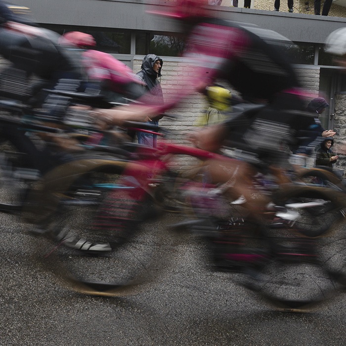 La Flèche Wallonne 2025 - Riders speed past fans in the rain on the Mur de Huy