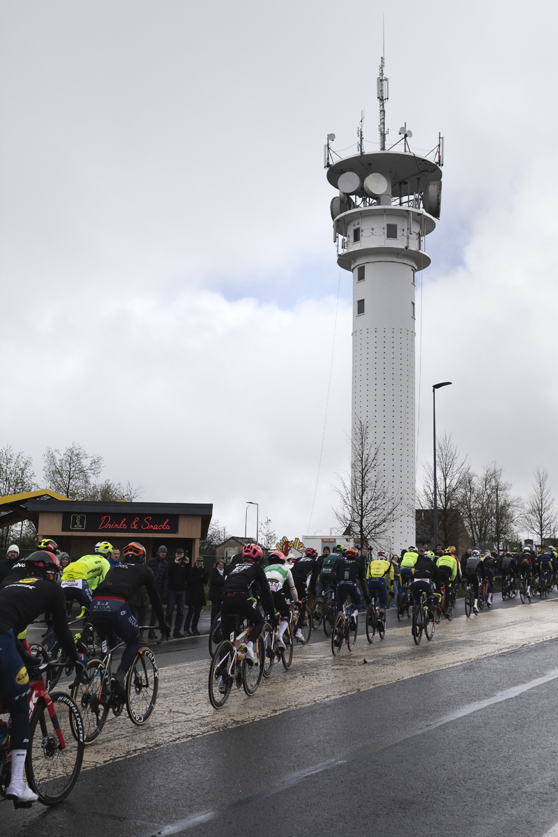 Liège-Bastogne-Liège 2024 - Riders pass in front of a communications mast at Baraque Fraiture