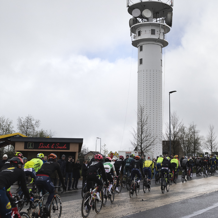 Liège-Bastogne-Liège 2024 - Riders pass in front of a communications mast at Baraque Fraiture