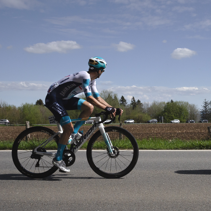 Liege Bastogne Liege 2025 - Pello Bilbao of Bahrain - Victorious on the road in front of a ploughed field