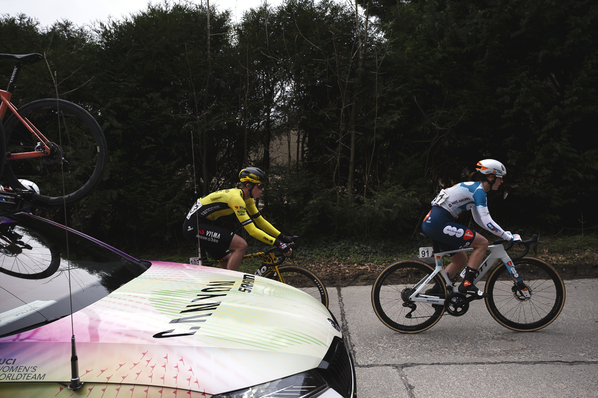 Omloop Het Nieuwsblad Vrouwen 2024 - Linda Riedmann of Team Visma - Lease a Bike & Francesca Barale of Team dsm-firmenich PostNL with a team car on Kapellestraat