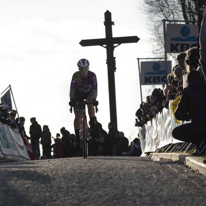 Omloop Nieuwsblad Vrouwen 2025 - Elena Cecchini, of Team SD Worx - Protime with the crucifix behind her as she crests the Muur van Geraardsbergen