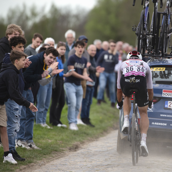 Paris Roubaix 2024 - António Morgado of UAE Team Emirates follows a race car on Camphin-en-Pévèle
