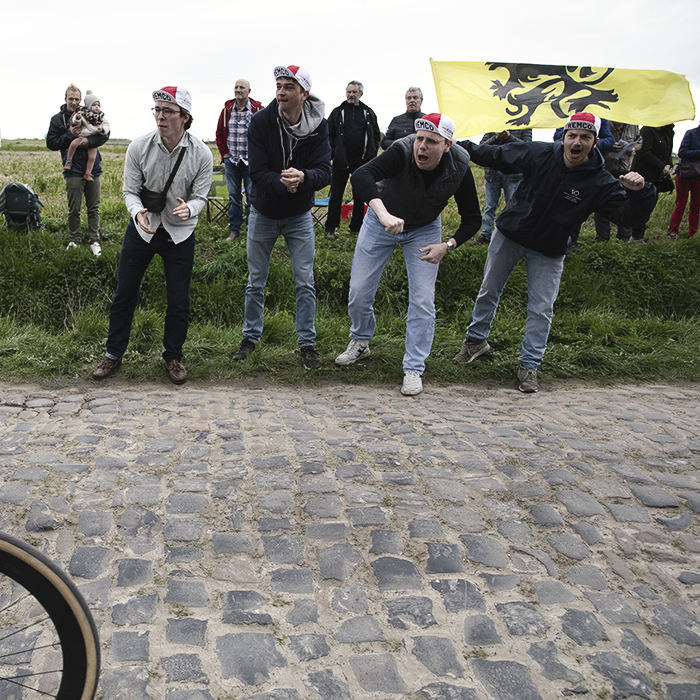 Paris Roubaix 2024 - Belgian fans fly a Flemish flag and provide enthusiastic support for riders on Carrefour de l’Arbre