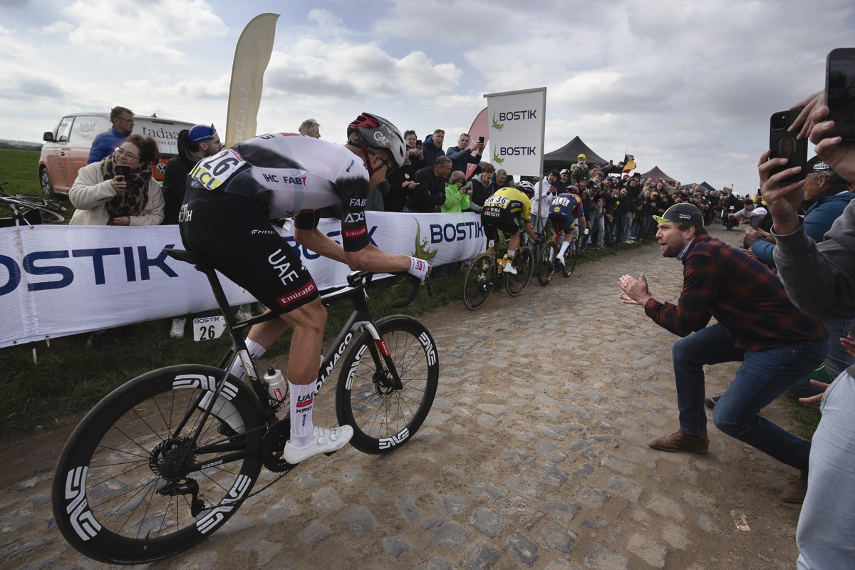 Paris Roubaix 2025 - A fan leans into the road to encourage Florian Vermeersch