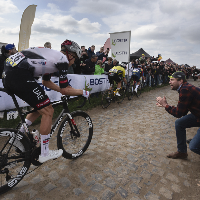 Paris Roubaix 2025 - A fan leans into the road to encourage Florian Vermeersch