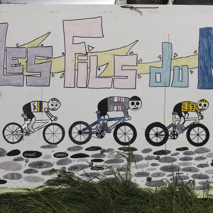 Paris Roubaix 2025 - A children’s home made sign depicts three of the race favourites - Les Fils du Nord - The Sons of the North