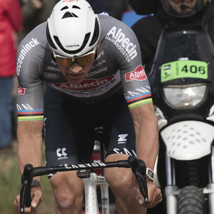 Paris Roubaix 2025 - Mathieu van der Poel with determination showing on his face is followed closely by the TV motorbike