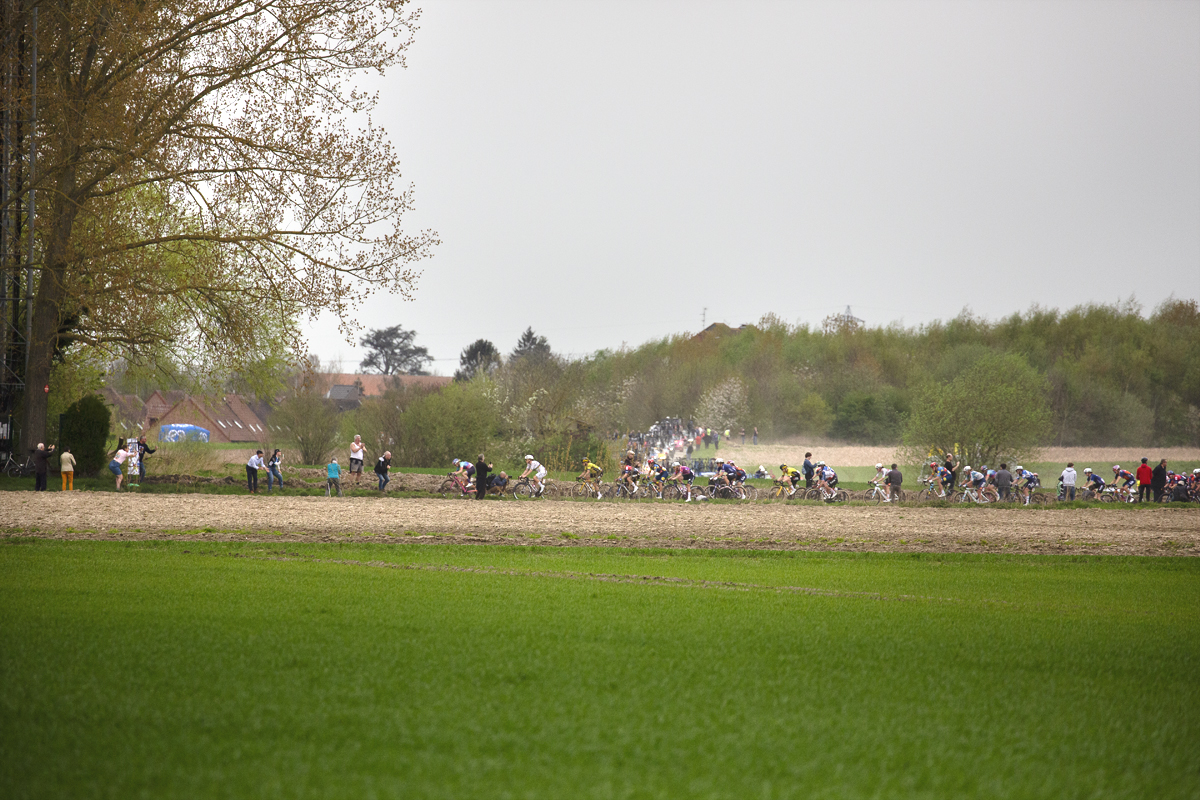 Paris Roubaix Femmes 2024 - Riders seen across the fields on the Cysoing à Bourghelles sector