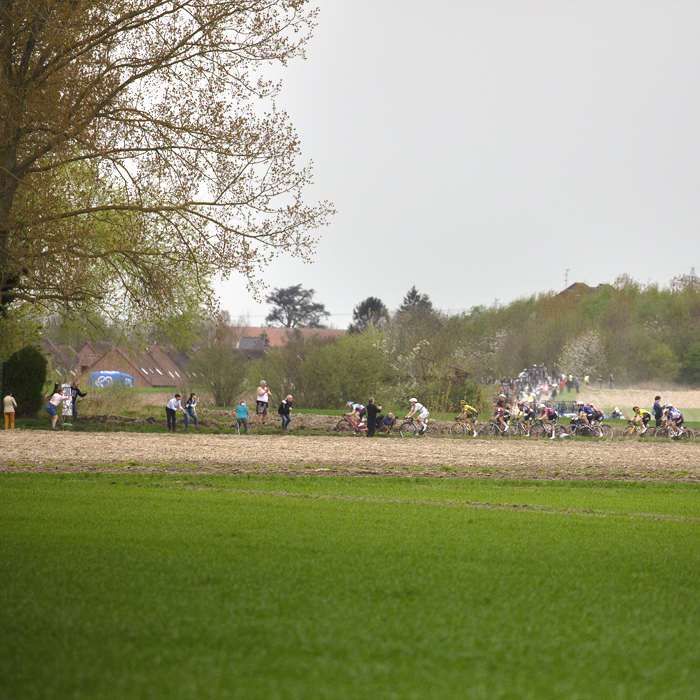 Paris Roubaix Femmes 2024 - Riders seen across the fields on the Cysoing à Bourghelles sector
