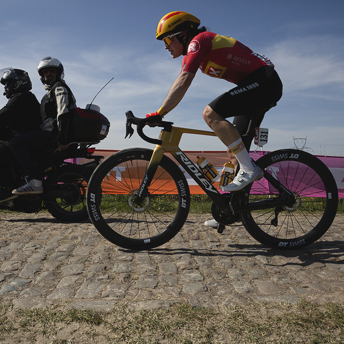 Paris Roubaix Femmes 2025 - Teuntje Beekhuis of Uno-X Mobility with a commissaire on a motorbike to one side