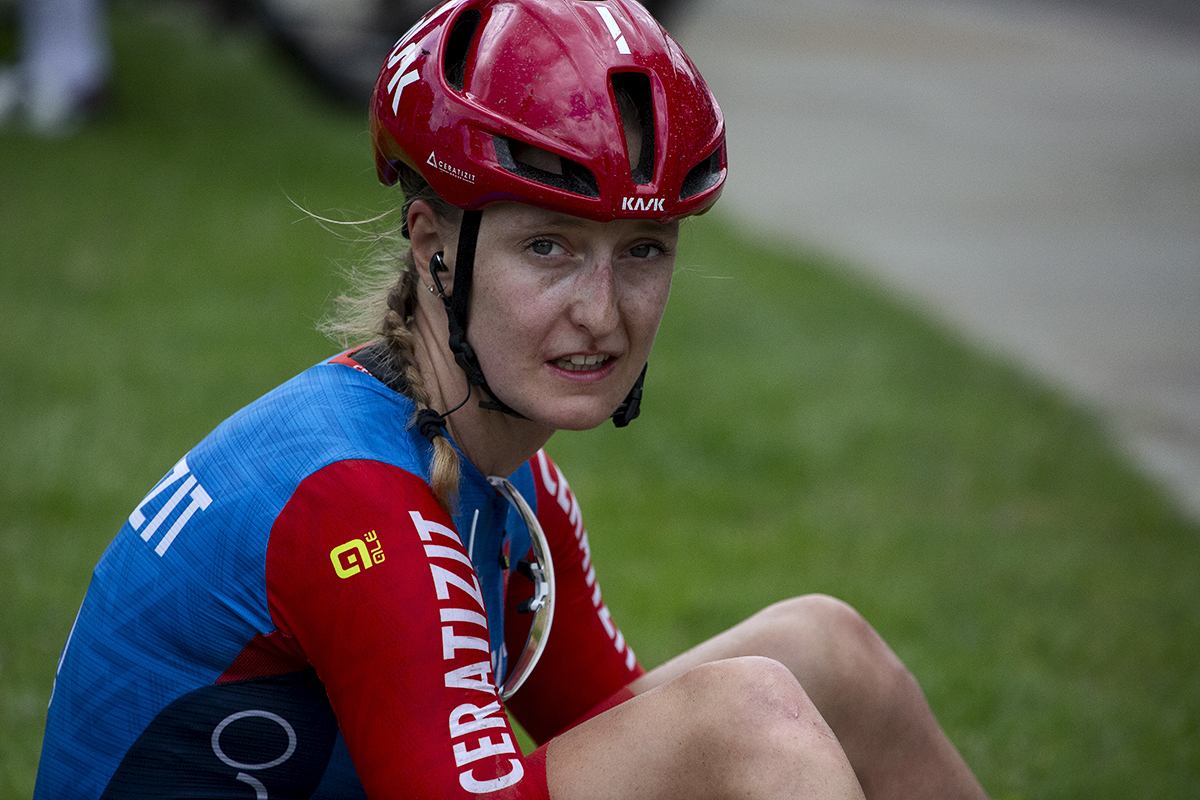 RideLondon Classique 2024 - Cédrine Kerbaol of CERATIZIT-WNT Pro Cycling Team sits of the grass exhausted after stage one of the race