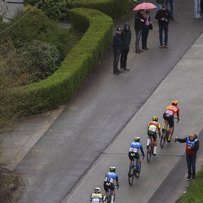 Ronde van Vlaanderen 2024 - A view from above as a soigneur holds out bidons