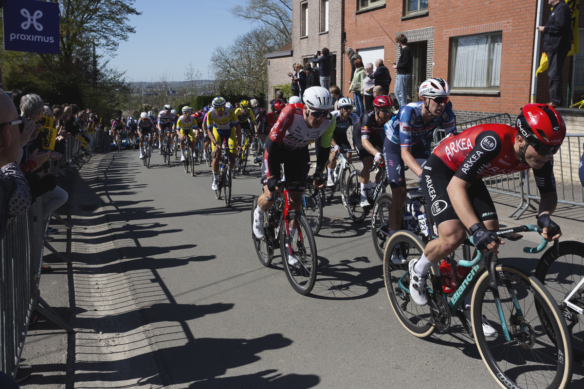 Ronde van Vlaanderen 2025 - Riders on the climb of Wolvenberg with fans using the walls of houses as a vantage point