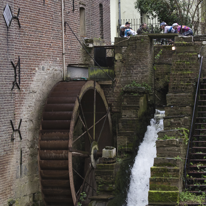 Ronde van Vlaanderen Vrouwen 2024 - Riders seen crossing the mill stream with the waterwheel clearly visible