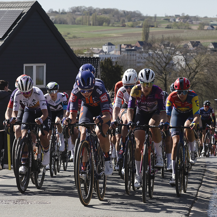 Ronde van Vlaanderen Vrouwen 2025 - Riders on Berendries the town and Belgian countryside in the distance