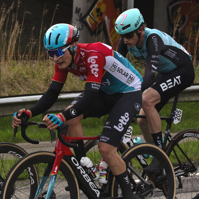 Scheldeprijs 2024 - Riders pass in front of graffiti covered walls in Rilland