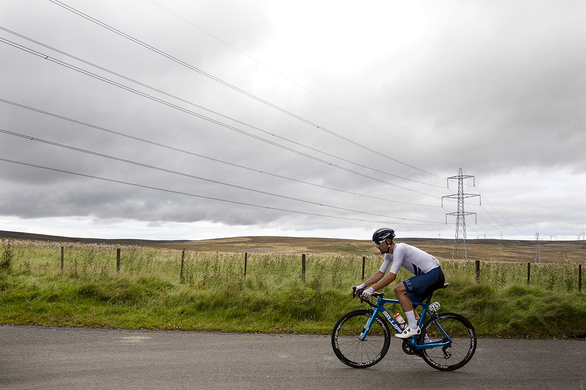 Tour of Britain 2021 - Ross Lamb of SwiftCarbon Pro Cycling passes through the moorland of Crow Moss in the Scottish Borders